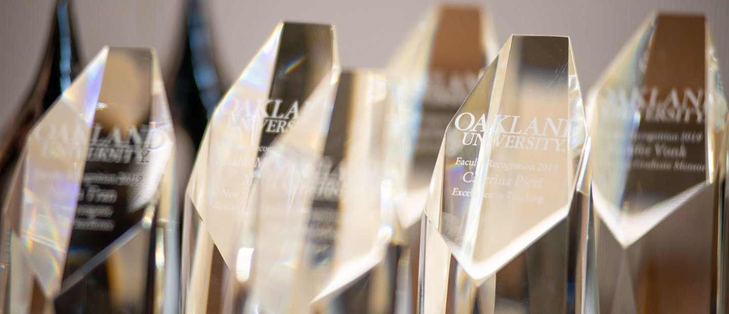 一排排奥克兰大学颁发给教员的万博ManBetX登录玻璃奖杯。